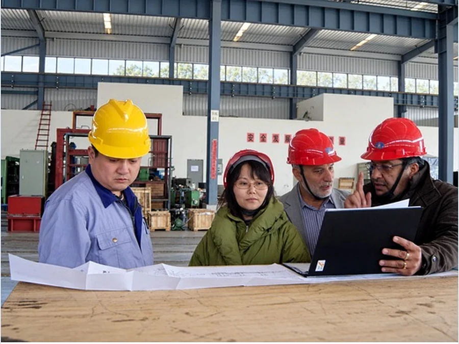 Consultant reviewing production line status at Dalian Field